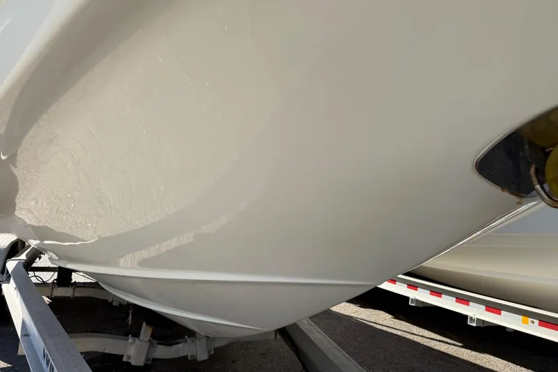 Slide: The Image of 2019 Crownline Eclipse E255 XS boat hull on trailer, close-up view. - 42