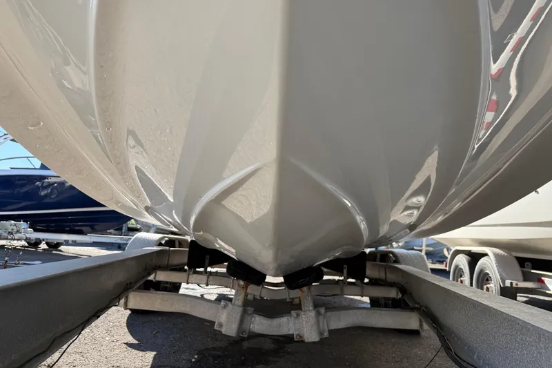 Slide: The Image of 2019 Crownline Eclipse E255 XS boat hull on trailer, close-up view. - 43