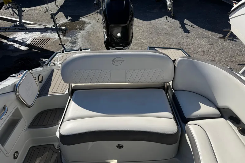 Slide: The Image of 2019 Crownline Eclipse E255 XS boat interior with cushioned seating and modern design. - 6