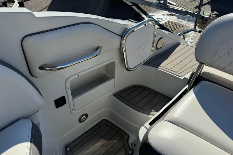 Slide: The Image of 2019 Crownline Eclipse E255 XS boat interior with storage compartment and seating. - 8