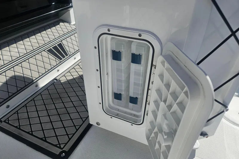 Slide: The Image of 2021 Wellcraft 242 Fisherman boat storage compartment with open hatch and non-slip flooring. - 12