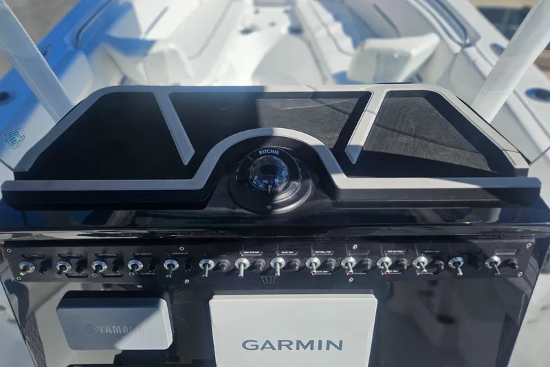 Slide: The Image of 2021 Wellcraft 242 Fisherman boat dashboard with Garmin navigation and Yamaha controls. - 18