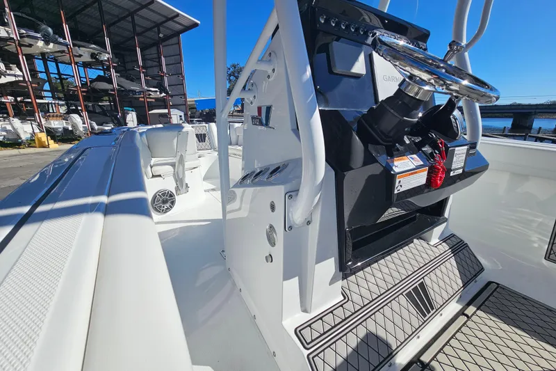 Slide: The Image of 2021 Wellcraft 242 Fisherman boat interior with steering console and seating. - 21