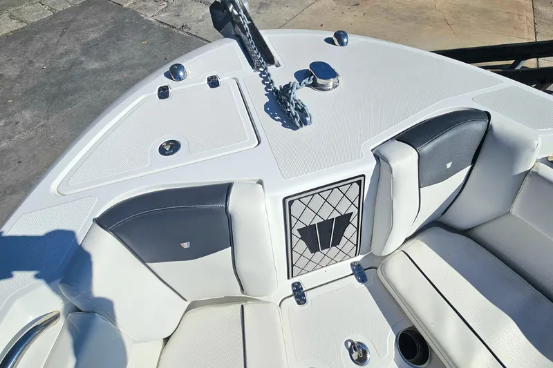 Slide: The Image of 2021 Wellcraft 242 Fisherman boat interior with cushioned seating and anchor chain. - 24