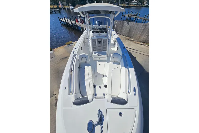 Slide: The Image of 2021 Wellcraft 242 Fisherman boat docked, showcasing spacious deck and seating area. - 25