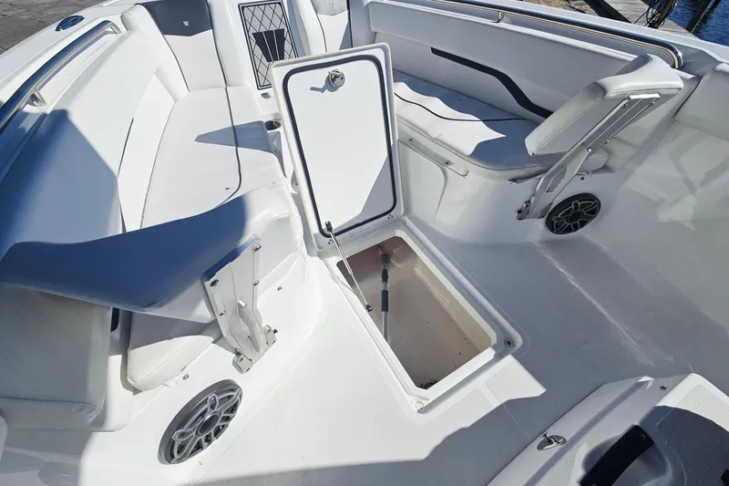 Slide: The Image of 2021 Wellcraft 242 Fisherman boat interior with open storage compartment and seating. - 26