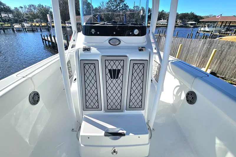 Slide: The Image of 2021 Wellcraft 242 Fisherman boat interior with console and seating, docked by the water. - 27