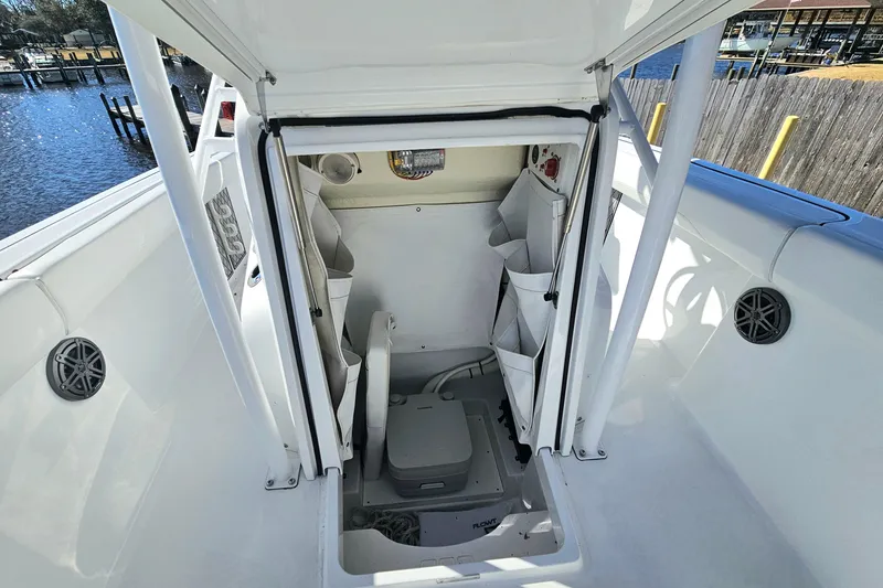 Slide: The Image of 2021 Wellcraft 242 Fisherman boat interior with storage compartments and marine equipment. - 28