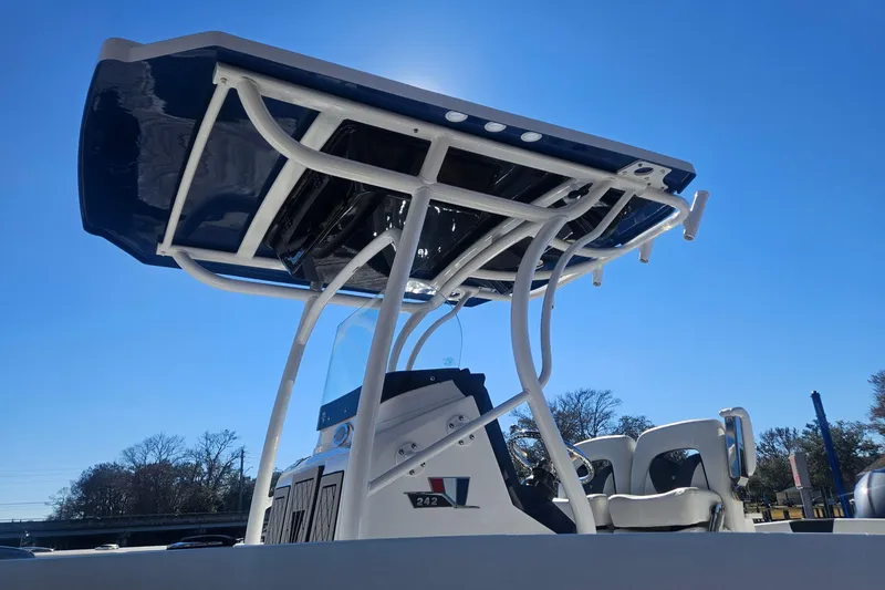 Slide: The Image of 2021 Wellcraft 242 Fisherman boat with T-top under clear blue sky. - 29