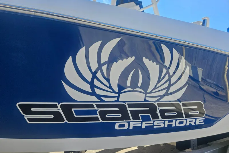 Slide: The Image of 2021 Wellcraft 242 Fisherman boat with Scarab Offshore logo on blue hull. - 30