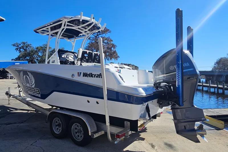 Slide: The Image of 2021 Wellcraft 242 Fisherman boat on trailer, featuring Yamaha outboard motor. - 4