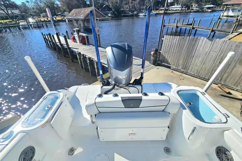 Slide: The Image of 2021 Wellcraft 242 Fisherman boat with powerful engine docked by a scenic waterfront. - 8