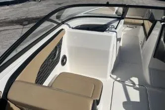 Slide: The Image of 2024 Sea Ray SPX 210 Outboard boat interior with tan seating and sleek design. - 10