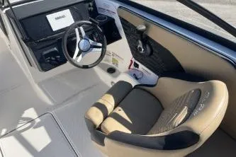 Slide: The Image of 2024 Sea Ray SPX 210 Outboard boat interior with steering wheel and seating. - 9