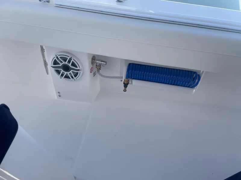 Slide: The Image of Regulator 31 boat 2025 with speaker and blue hose reel. - 11