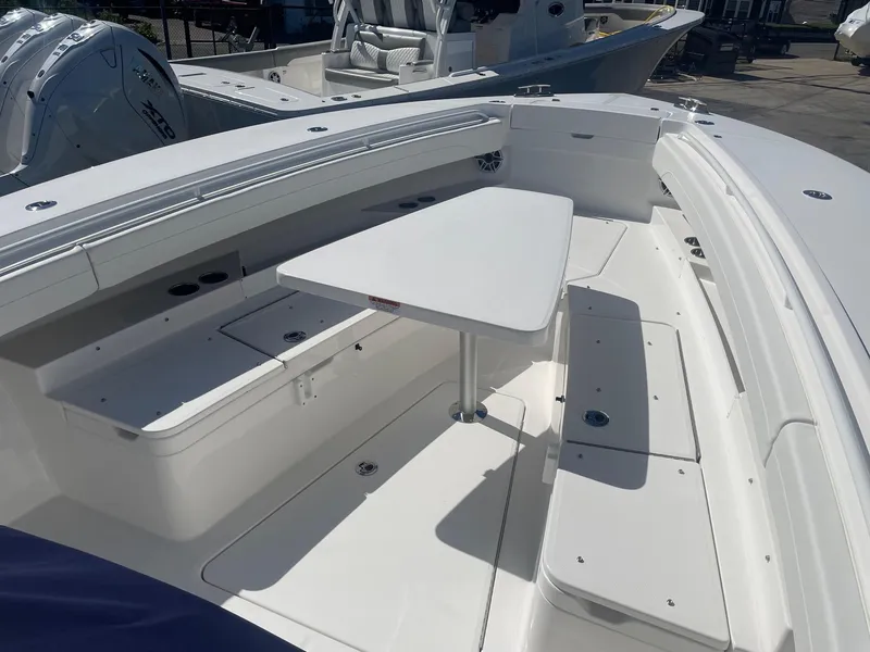 Slide: The Image of 2025 Regulator 31 boat with outdoor seating and table. - 12