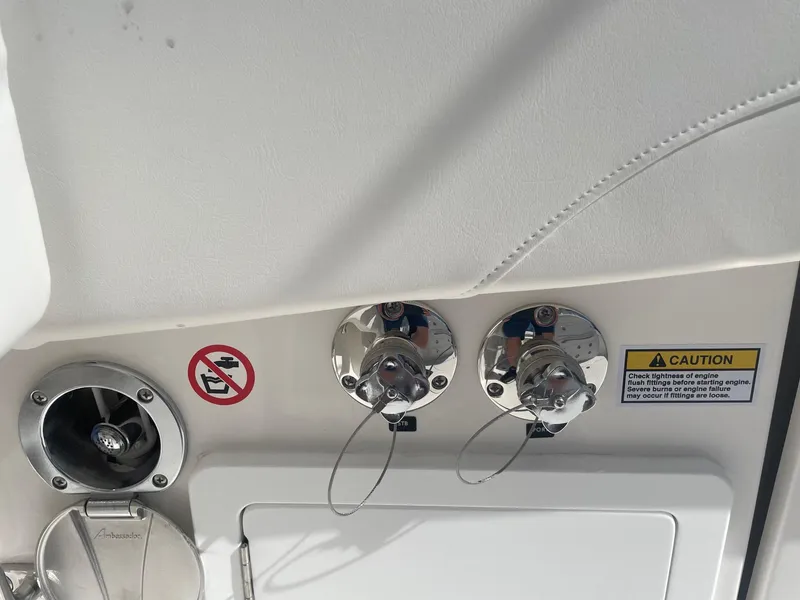 Slide: The Image of Regulator 31 boat 2025: Fuel connections and caution labels. - 25