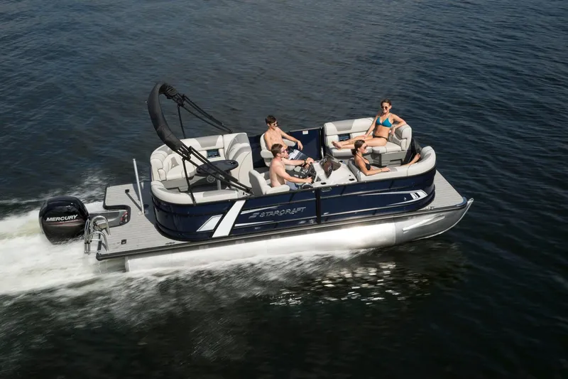 The Image of 2026 Starcraft EXS 1 Q DH pontoon boat cruising with passengers on a lake. - 1