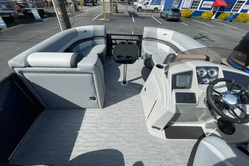 Slide: The Image of 2026 Starcraft EXS 1 Q DH boat interior with modern seating and control panel. - 11