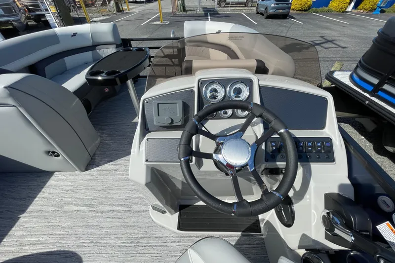 Slide: The Image of 2026 Starcraft EXS 1 Q DH boat interior with steering wheel and seating area. - 12