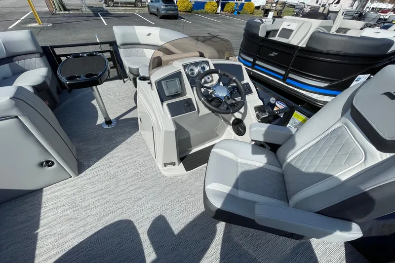 Slide: The Image of 2026 Starcraft EXS 1 Q DH boat interior with modern helm and seating. - 13