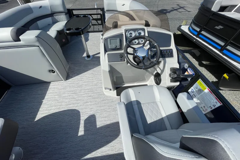 Slide: The Image of 2026 Starcraft EXS 1 Q DH boat interior with modern steering and seating. - 14
