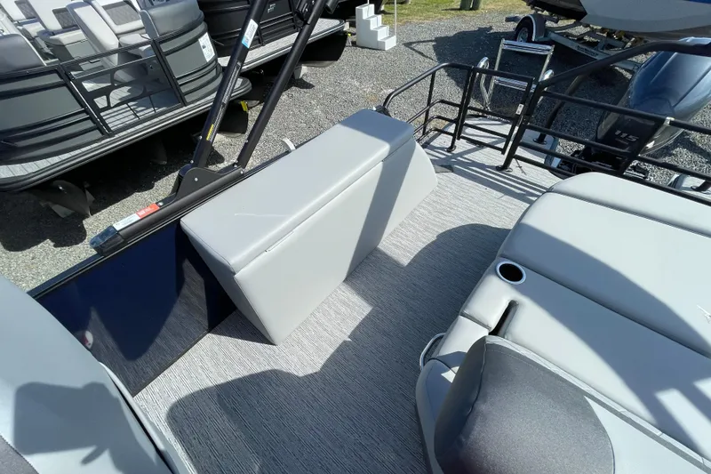 Slide: The Image of 2026 Starcraft EXS 1 Q DH boat interior with gray seating and cup holders. - 16