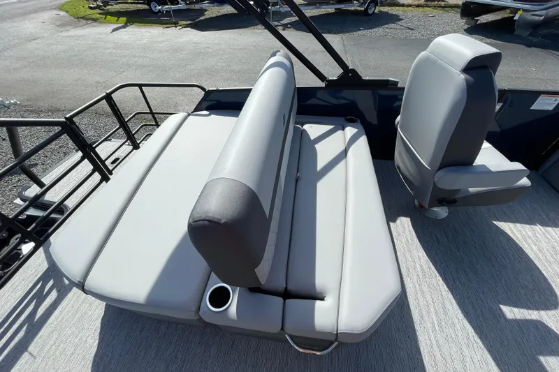 Slide: The Image of 2026 Starcraft EXS 1 Q DH boat interior with gray seating and cup holder. - 4