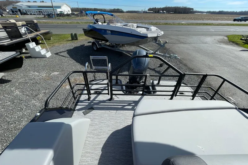 Slide: The Image of 2026 Starcraft EXS 1 Q DH boat on display, featuring sleek design and modern outboard motor. - 5