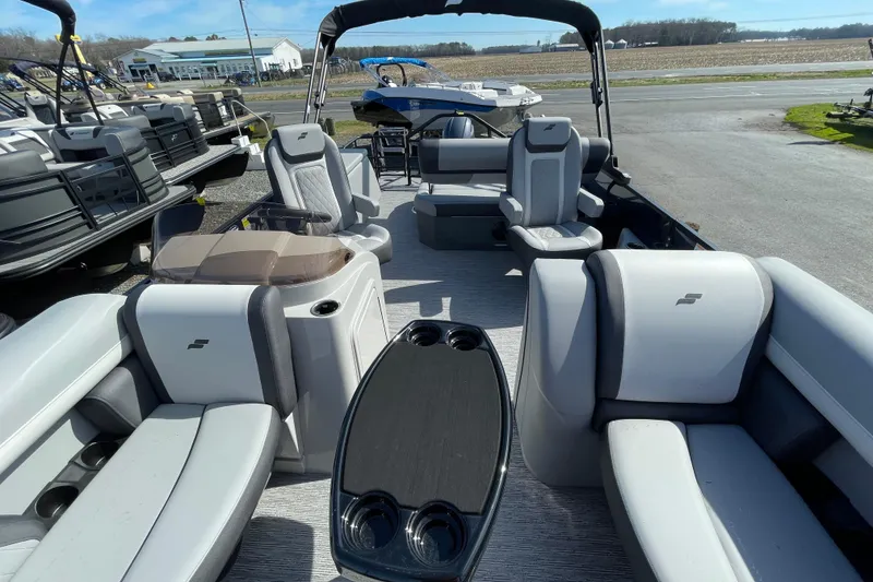 Slide: The Image of 2026 Starcraft EXS 1 Q DH pontoon boat interior with modern seating and table. - 6