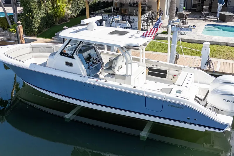 Slide: The Image of 2023 Pursuit S 328 Sport boat docked, featuring sleek design and modern amenities. - 2