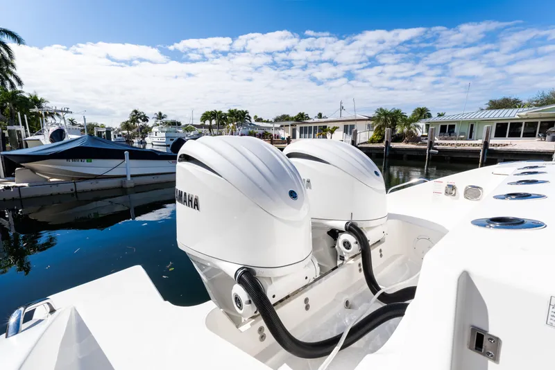 Slide: The Image of 2023 Pursuit S 328 Sport boat with Yamaha engines docked in a marina. - 3