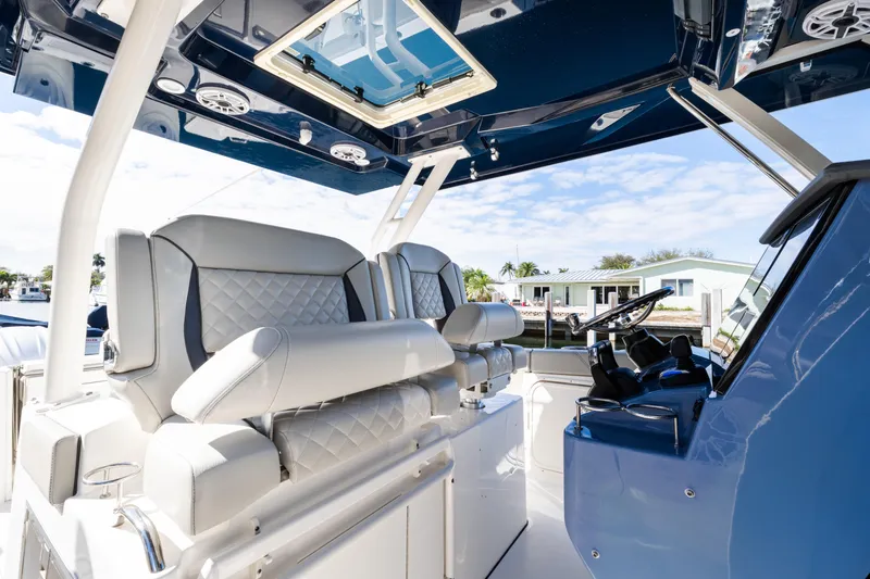 Slide: The Image of 2023 Pursuit S 328 Sport boat interior with luxurious seating and modern helm. - 7