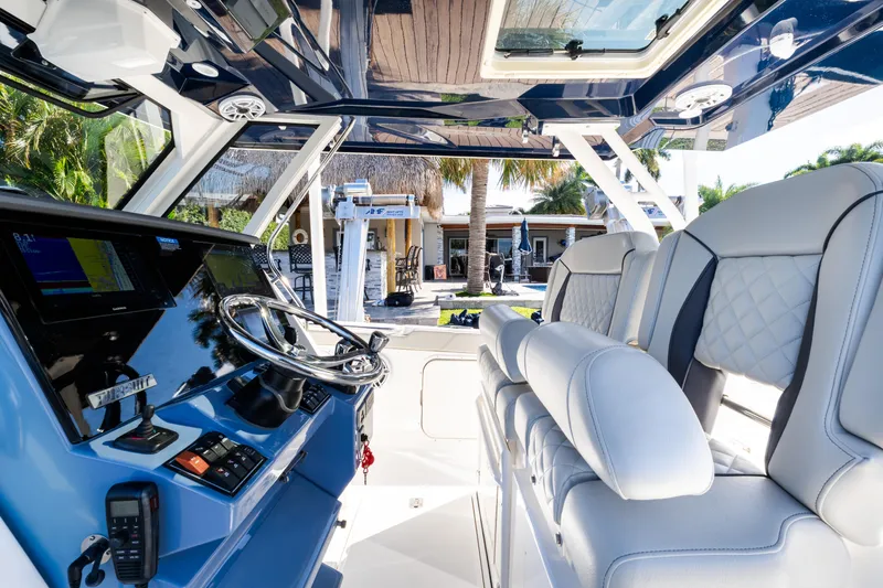 Slide: The Image of 2023 Pursuit S 328 Sport boat interior with modern helm and luxurious seating. - 8