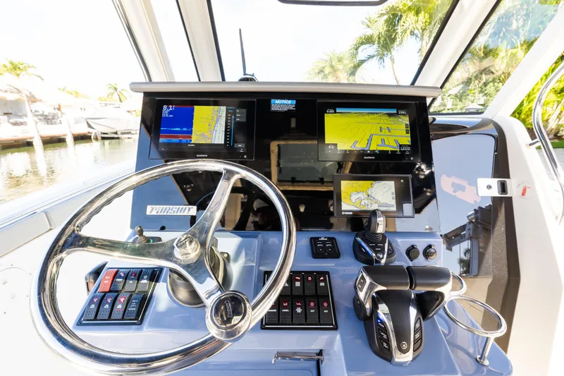 Slide: The Image of 2023 Pursuit S 328 Sport boat dashboard with advanced navigation displays and controls. - 9