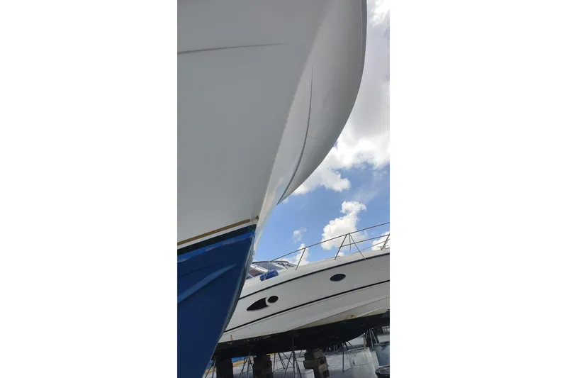 Slide: The Image of 1977 Bertram 46 Convertible yacht, close-up view, under a clear blue sky. - 3