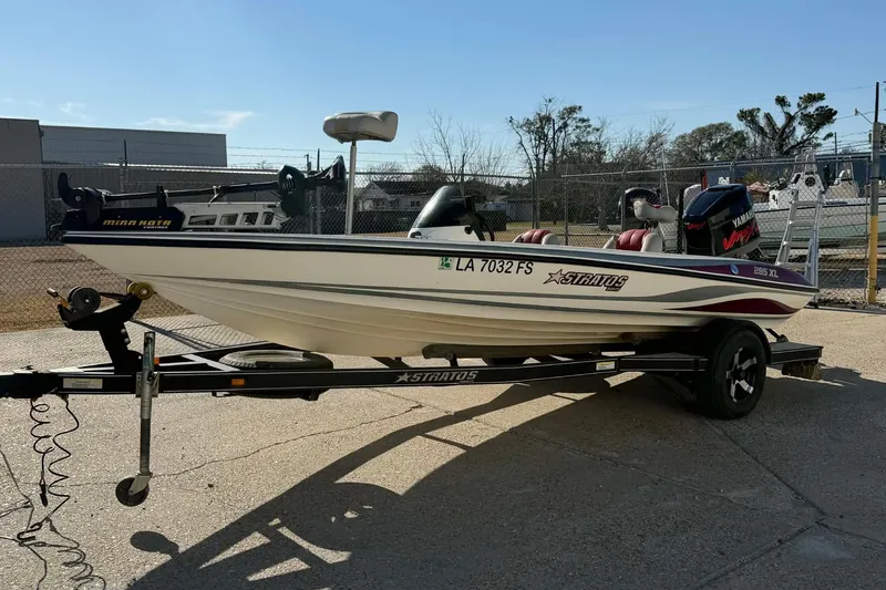 Slide: The Image of 2008 Stratos 285 XL boat on trailer, featuring Yamaha engine and Minn Kota trolling motor. - 2