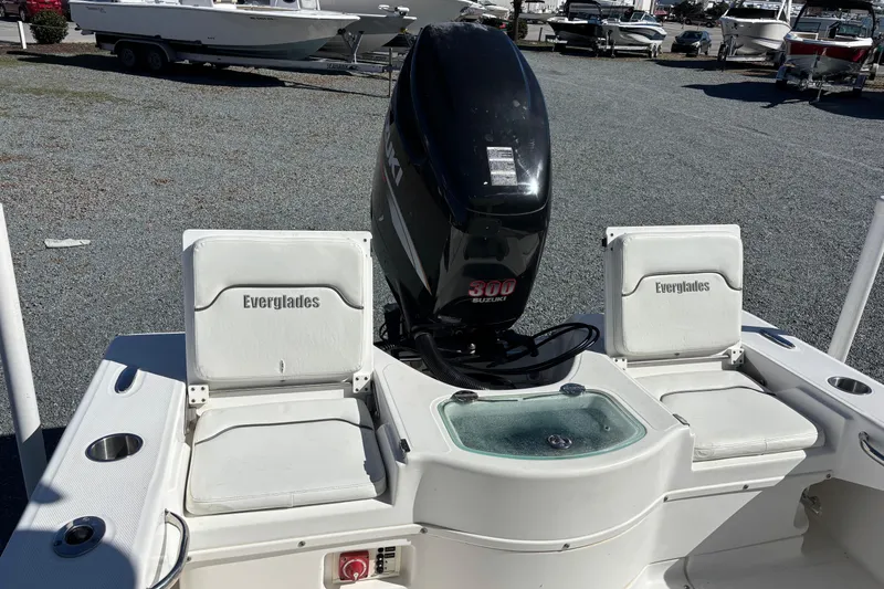 Slide: The Image of 2008 Everglades 243 Center Console boat with Suzuki 300 engine, docked outdoors. - 10