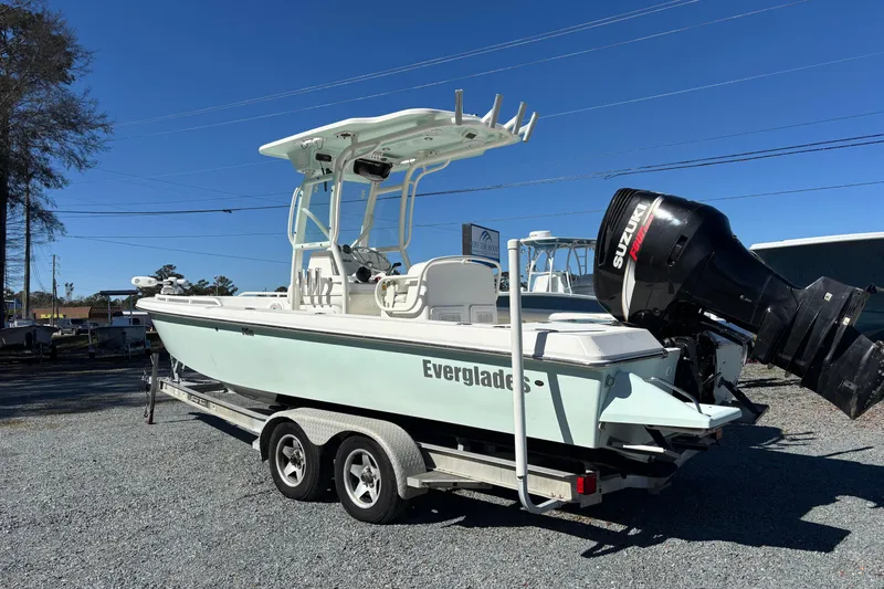 Slide: The Image of 2008 Everglades 243 Center Console boat on trailer, featuring Suzuki outboard motor. - 2