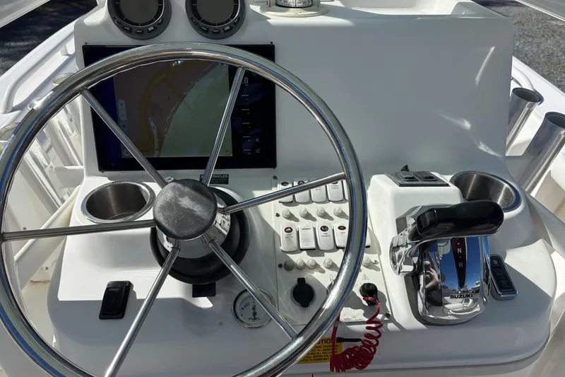 Slide: The Image of 2008 Everglades 243 Center Console boat dashboard with steering wheel and controls. - 5