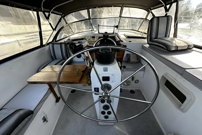 Slide: The Image of 1975 Morgan Out Island 51 yacht cockpit with steering wheel and seating area. - 12