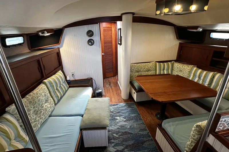 Slide: The Image of Interior of 1975 Morgan Out Island 51 sailboat with cozy seating and wooden table. - 15