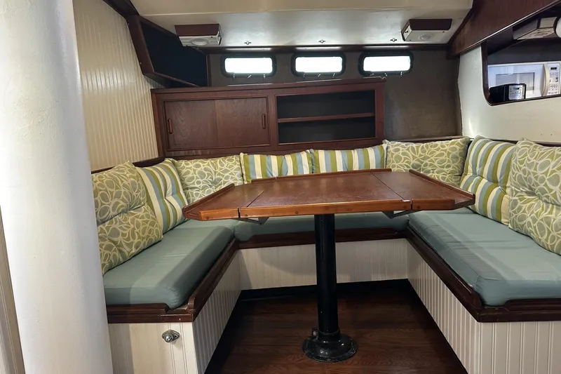 Slide: The Image of 1975 Morgan Out Island 51 yacht interior with cozy seating and wooden table. - 16