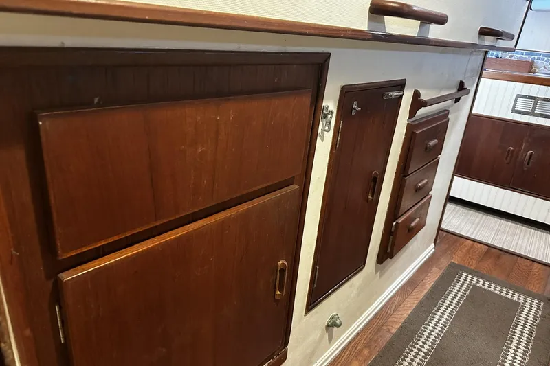 Slide: The Image of 1975 Morgan Out Island 51 interior with wooden cabinets and drawers. - 24