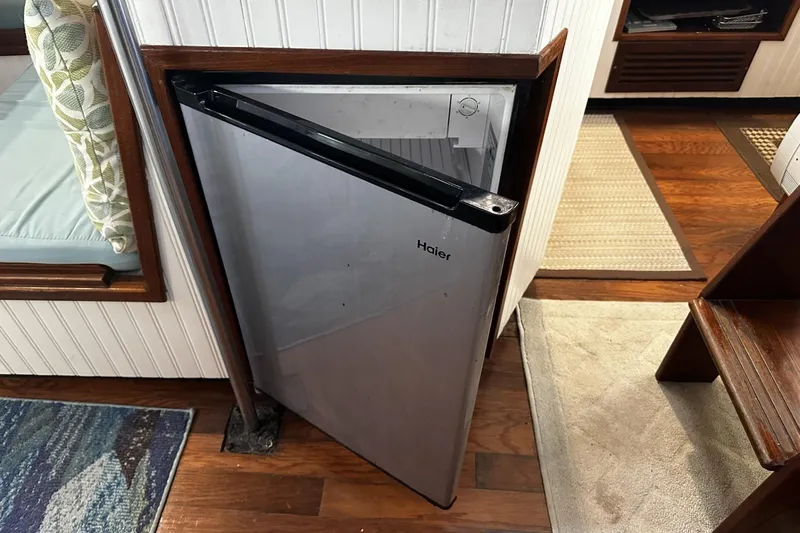 Slide: The Image of Open Haier mini fridge inside 1975 Morgan Out Island 51 yacht interior. - 25