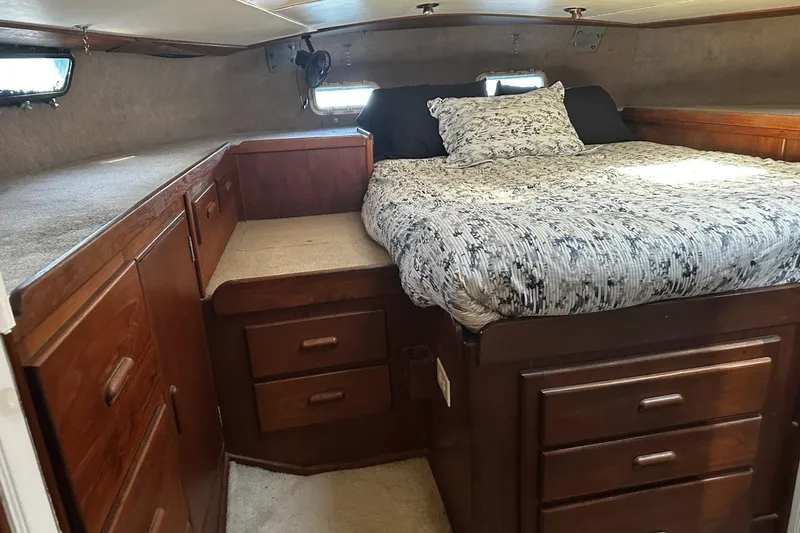 Slide: The Image of Cozy cabin interior of 1975 Morgan Out Island 51 sailboat with wooden storage and bed. - 26