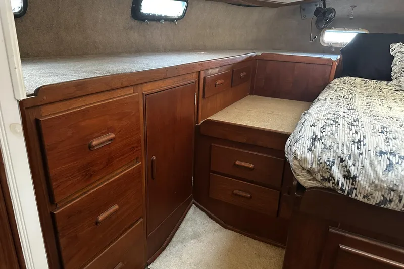 Slide: The Image of Cozy cabin interior of 1975 Morgan Out Island 51 with wooden storage and bed. - 27