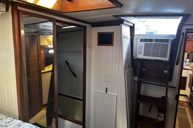 Slide: The Image of Interior of 1975 Morgan Out Island 51 yacht with wooden accents and air conditioning unit. - 29