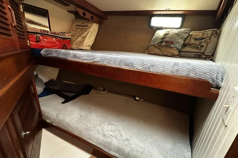 Slide: The Image of 1975 Morgan Out Island 51 cabin with bunk beds and nautical decor. - 38