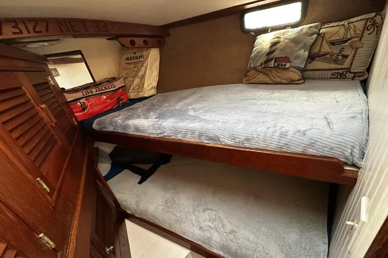 Slide: The Image of 1975 Morgan Out Island 51 cabin with bunk beds, nautical decor, and life jackets. - 39